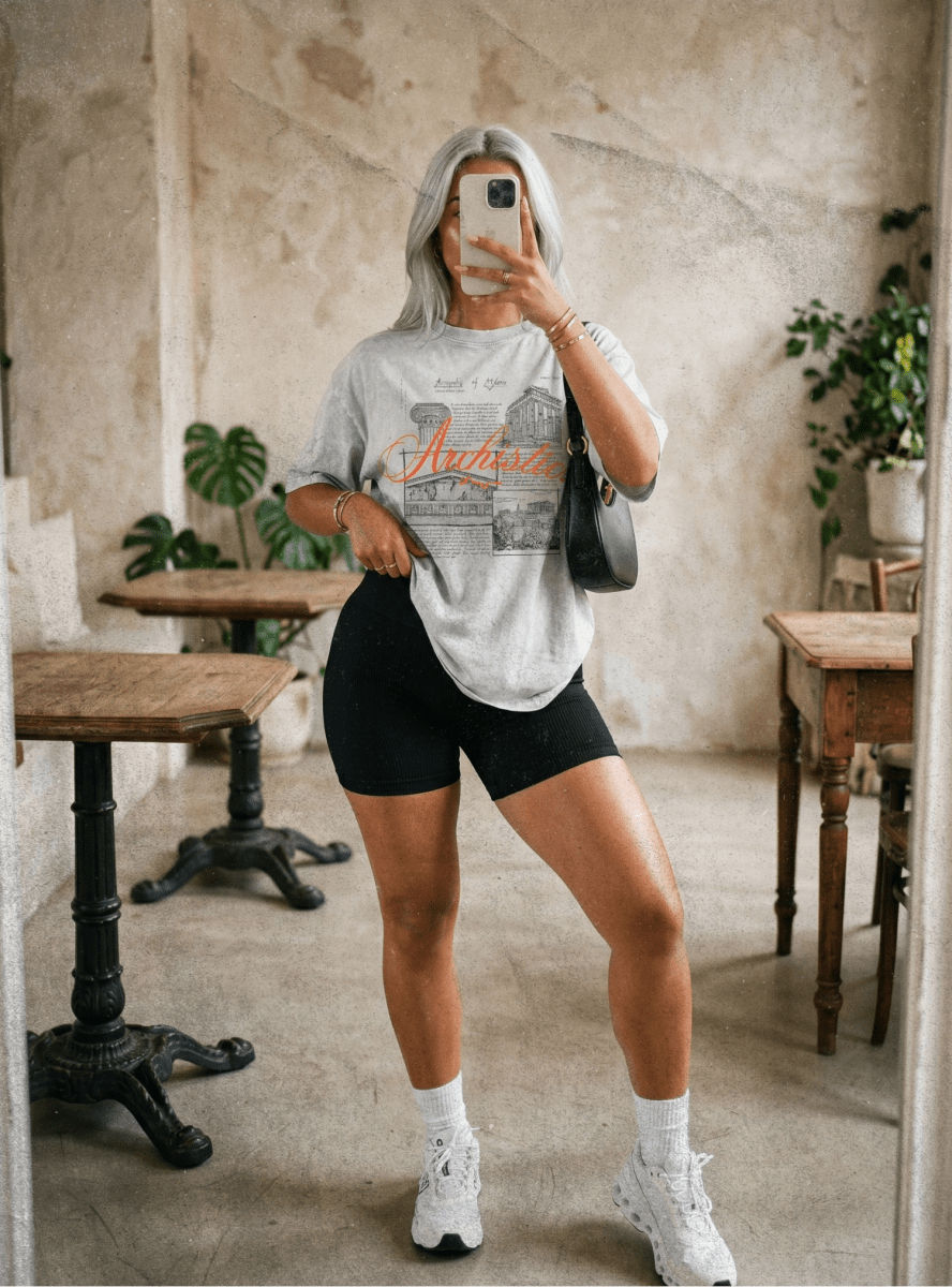 Girl wearing a gray Acropolis of Athens with black gym shorts and white shoes
