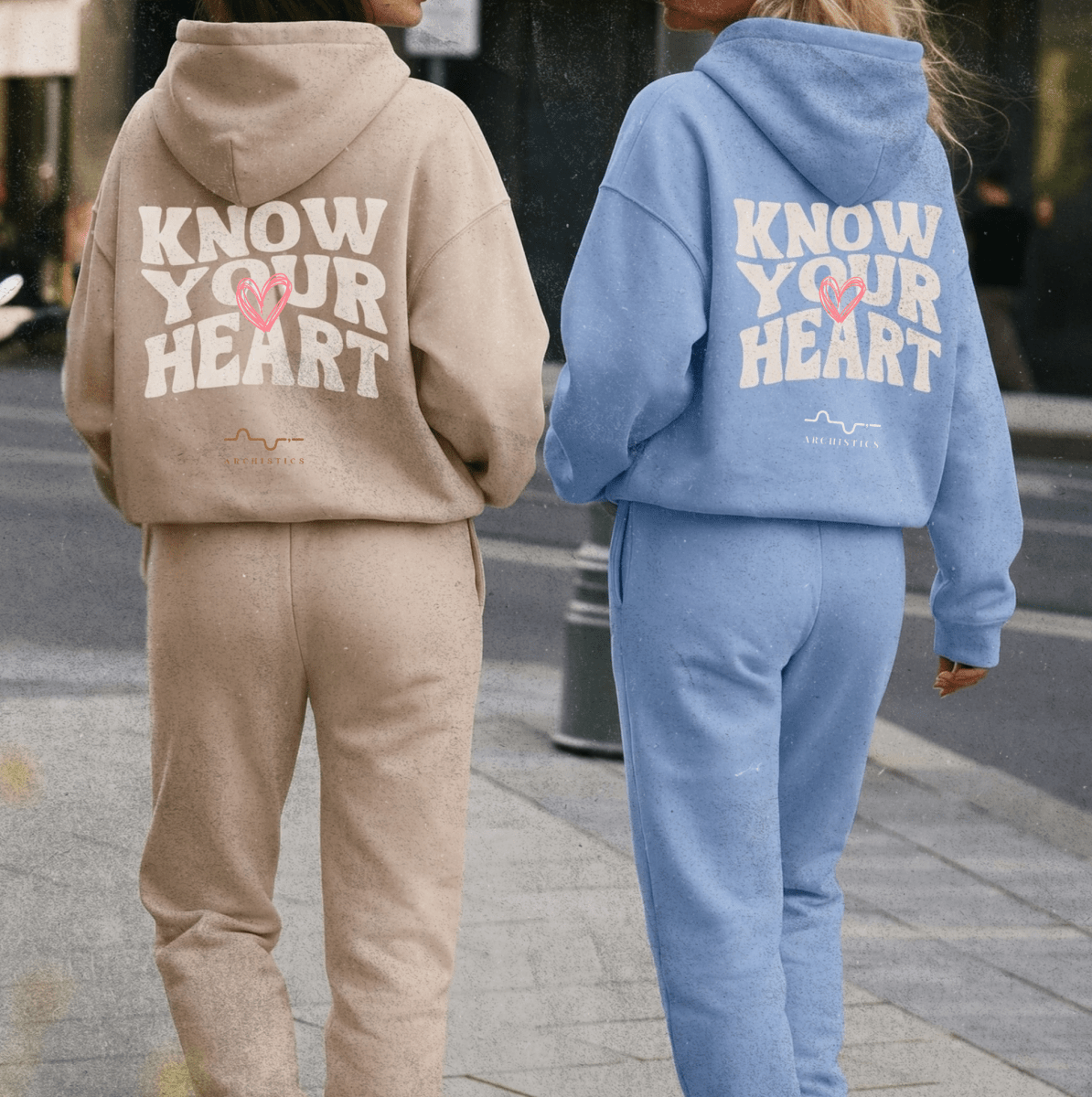 Two people wearing matching tracksuits with 'Know Your Heart' text on the back.