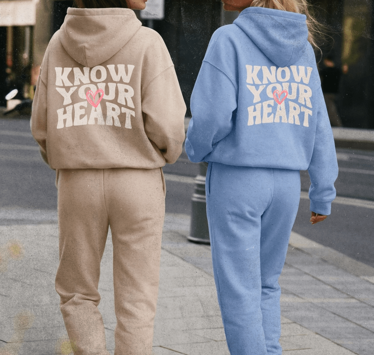 Two people wearing matching tracksuits with 'Know Your Heart' text on the back.