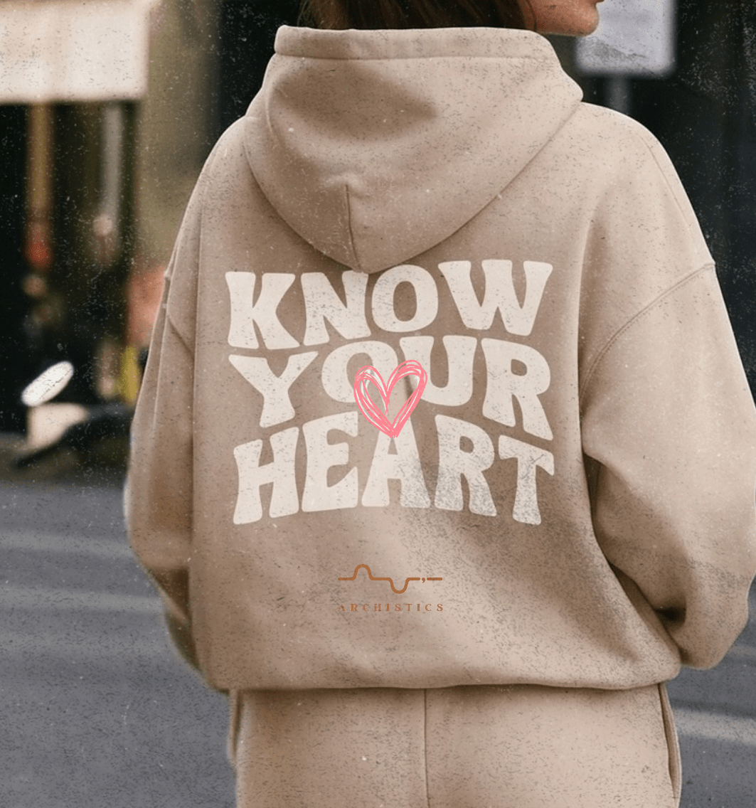 Two people wearing matching tracksuits with 'Know Your Heart' text on the back.